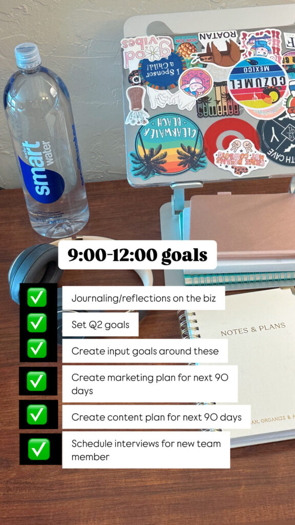 Picture of a desk with a water bottle, laptop, notebooks, headphones, and checklist for a small business owner quarterly planning retreat.